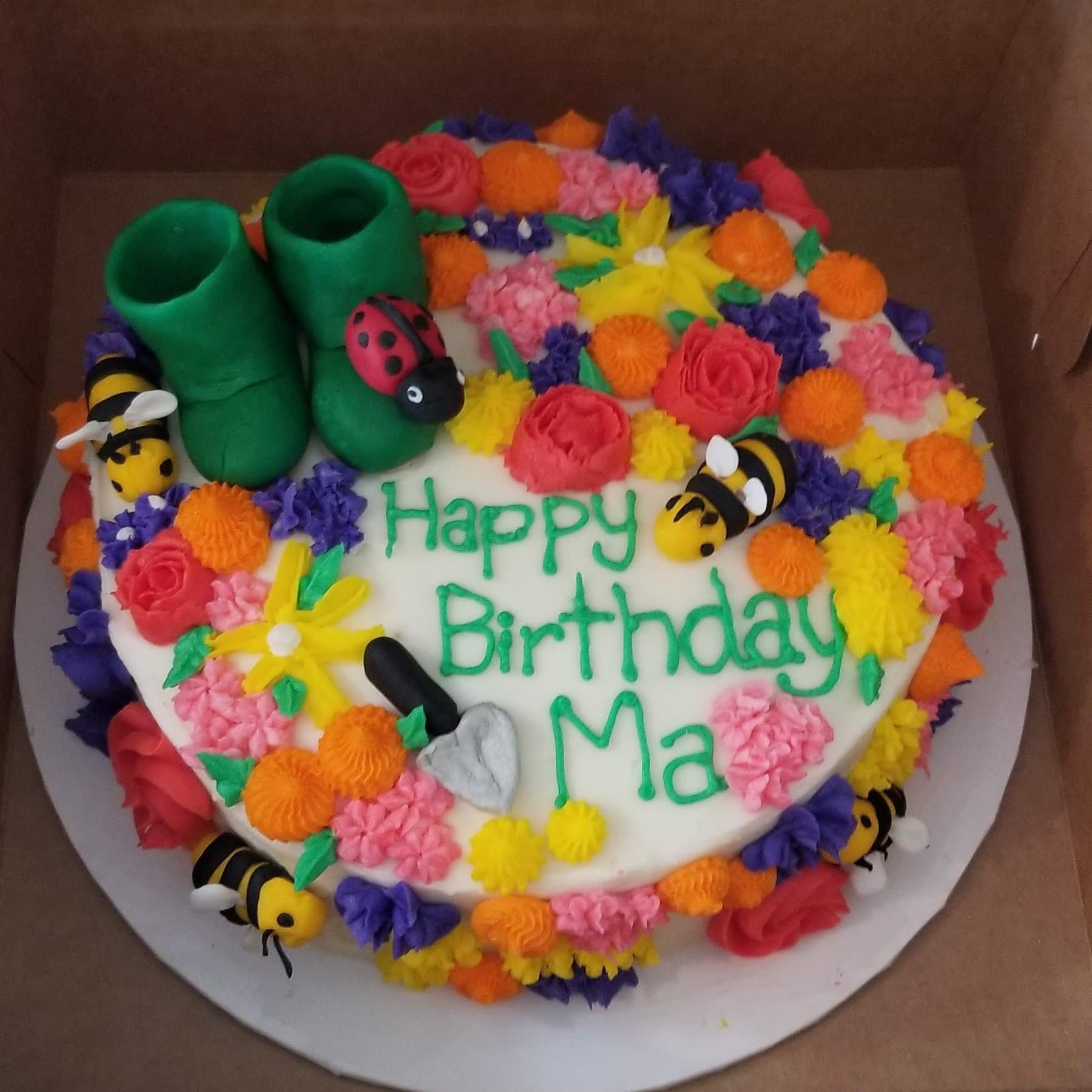 Flower garden birthday cake with bright buttercream blossoms by Jamie Cakes.