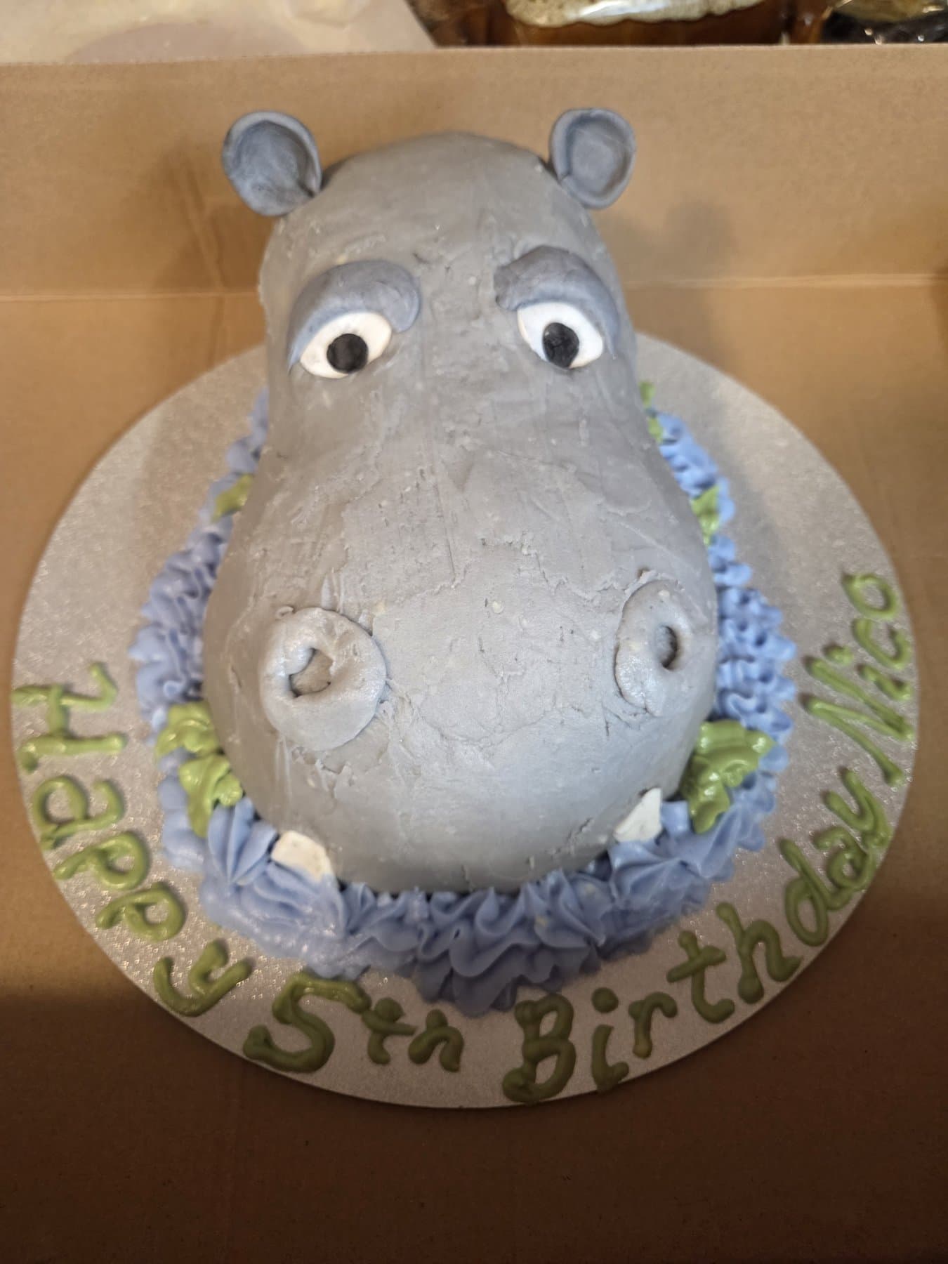 Sculpted hippo birthday cake with soft lavender details by Jamie Cakes.