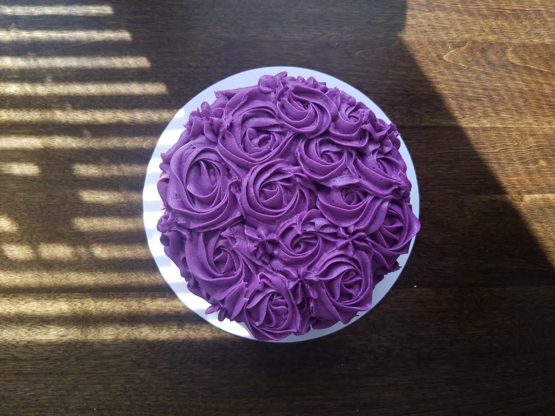 Top view of a purple rosette buttercream cake by Jamie Cakes.