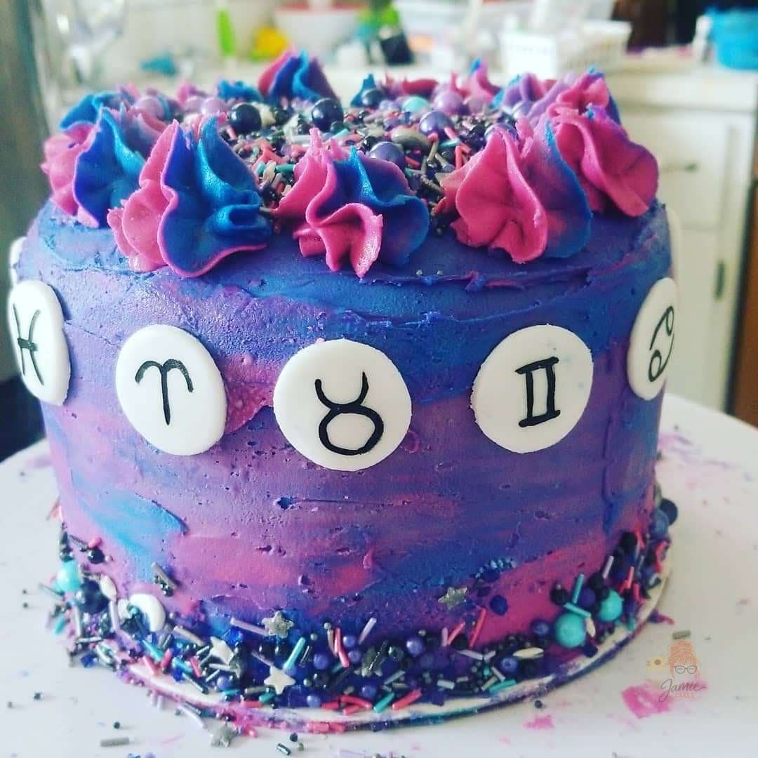 Galaxy zodiac birthday cake with bold purple and pink frosting by Jamie Cakes.